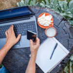 Home office concept, distant working during lockdown. A man, freelancer, working remotely in the farm at countryside, with cheese and ecological milk, online education and job, countryside lifestyle